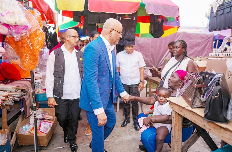 Dr Bharrat Jagdeo holding hand with a lovely lady and a child