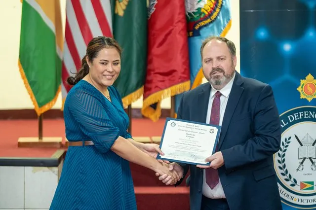 A graduate receiving their certificate