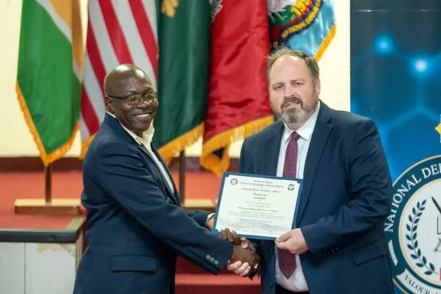 A graduate receiving their certificate