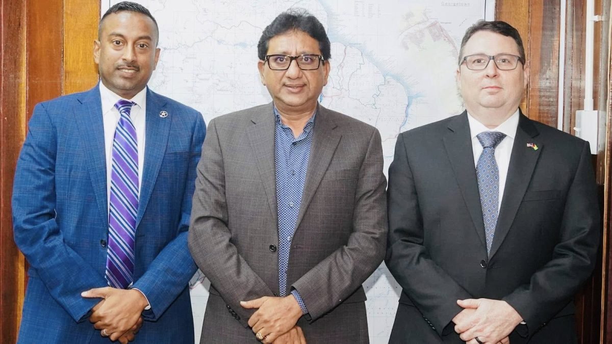 Attorney General Anil Nandlall SC (centre) with Sandy Rao (left) and Timothy Semons from United States Marshals Service officials