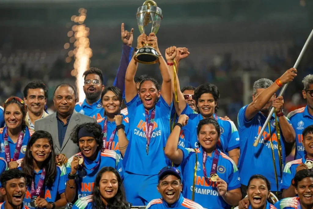 India’s captain Harmanpreet Kaur, center, lifts the trophy as team members and others celebrate after winning ICC Women's World Cup 2025