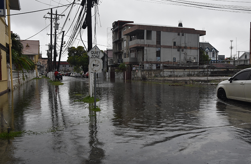 Floodwaters inundate sections of Georgetown following hours of heavy rainfall, as drainage systems come under pressure (Sachin Persaud photos)