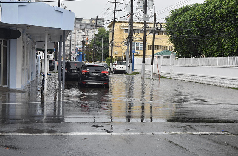 Floodwaters inundate sections of Georgetown following hours of heavy rainfall, as drainage systems come under pressure (Sachin Persaud photos)